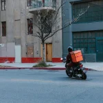 Motorcycle delivery rider transporting packages
