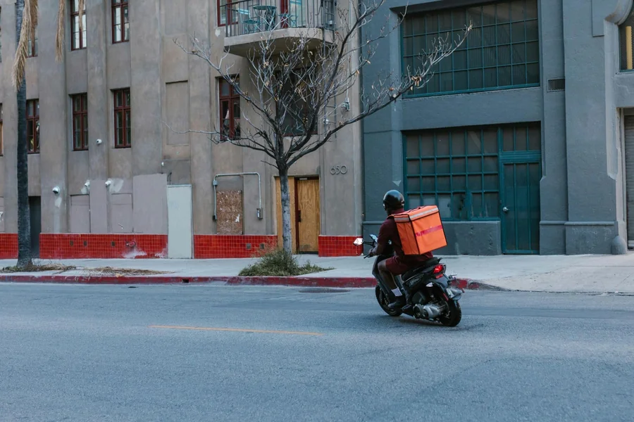 Motorcycle delivery rider transporting packages